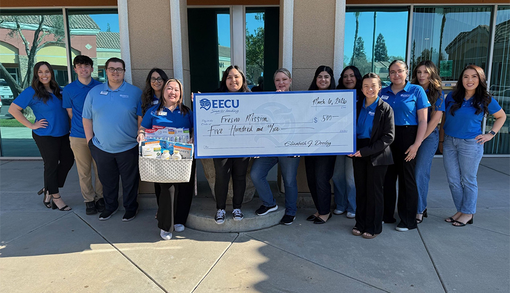 EECU Perrin branch staff holding donation basket and donation check for Fresno Mission